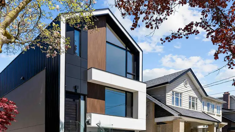 Modern black home with wood accents, the kind of listing shaping real estate market insights