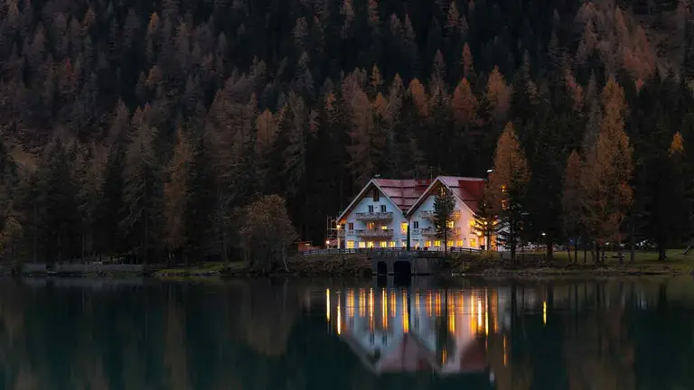 Lakeside house lit at dusk, located through an address lookup and property records search
