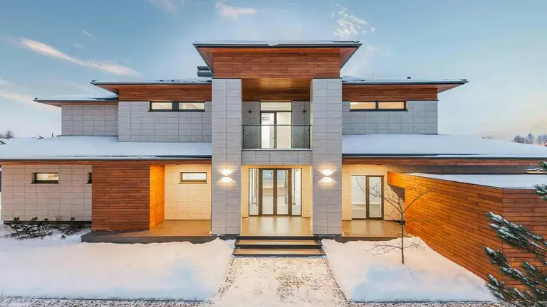 Modern flat-roof home in winter, an asset verified through attorney due diligence