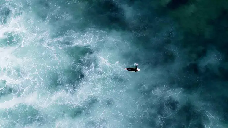 Aerial view of Pacific surf near San Diego, where lawyers title services protect coastal deals