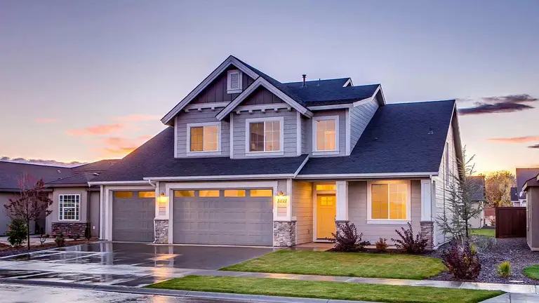 Suburban two-story home at dusk, the kind of property documented through property deed retrieval