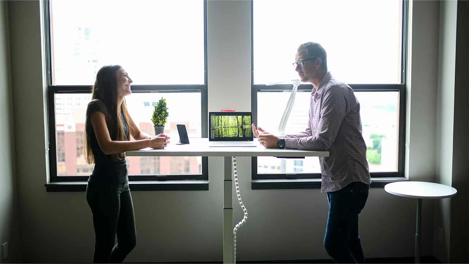 Title researchers comparing a retrieved property deed at a standing table in an office