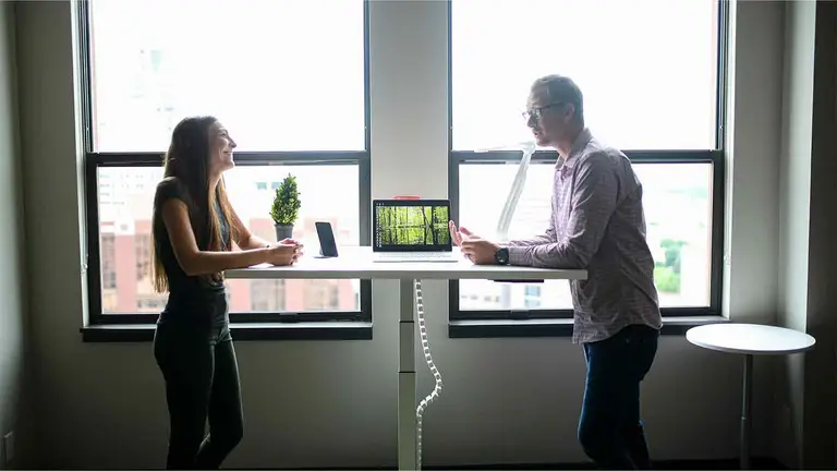 Title professionals verifying a retrieved deed at a standing table