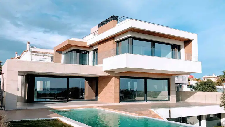 Modern villa with pool at dusk, an asset buyers verify property ownership on before wiring funds