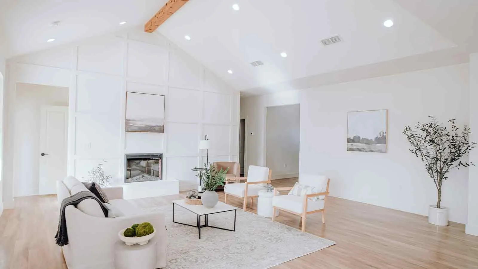 Vaulted white living room in a home with verified ownership and clear title