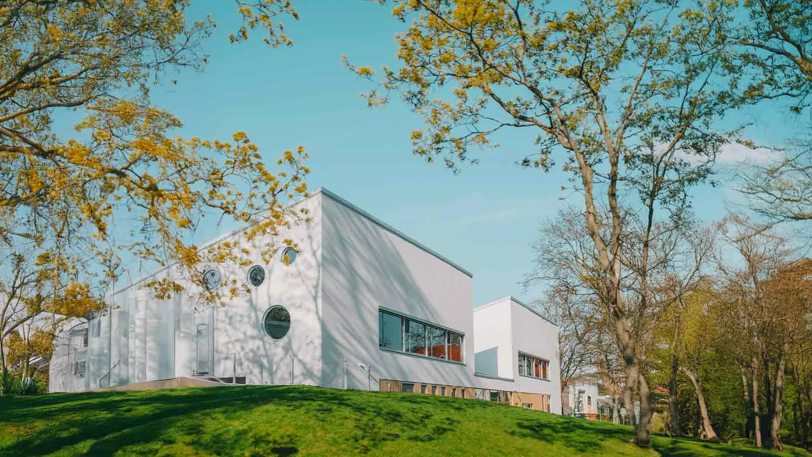 Modern building among trees, the kind of asset a property report describes