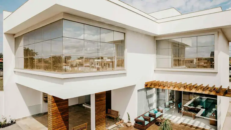 White modern house with balcony, protected by a professional property title search