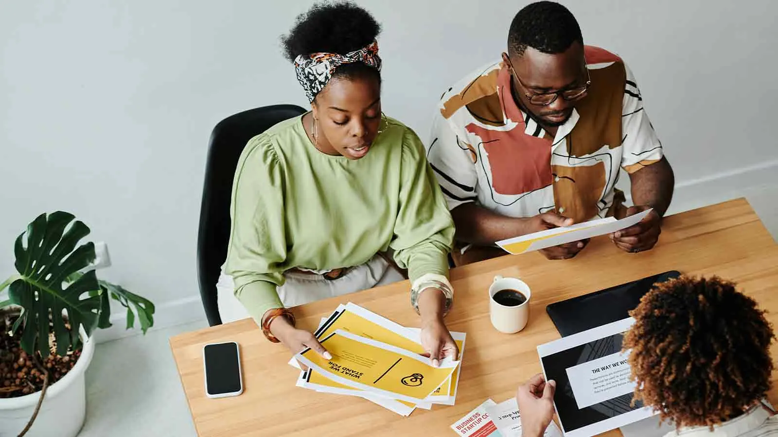 Couple sorting property title search documents with their advisor