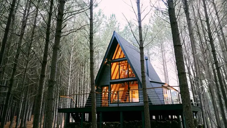 A-frame cabin among pines, a build shaped by a restrictive covenant on the land