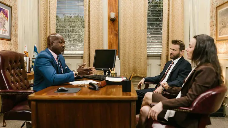 Attorney explaining New York TOD deed rules to clients at his desk