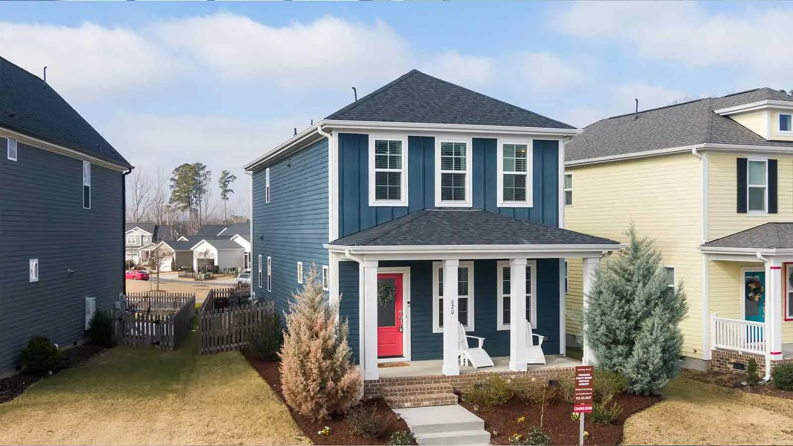 Blue and white homes on a suburban street screened for tax liens before sale