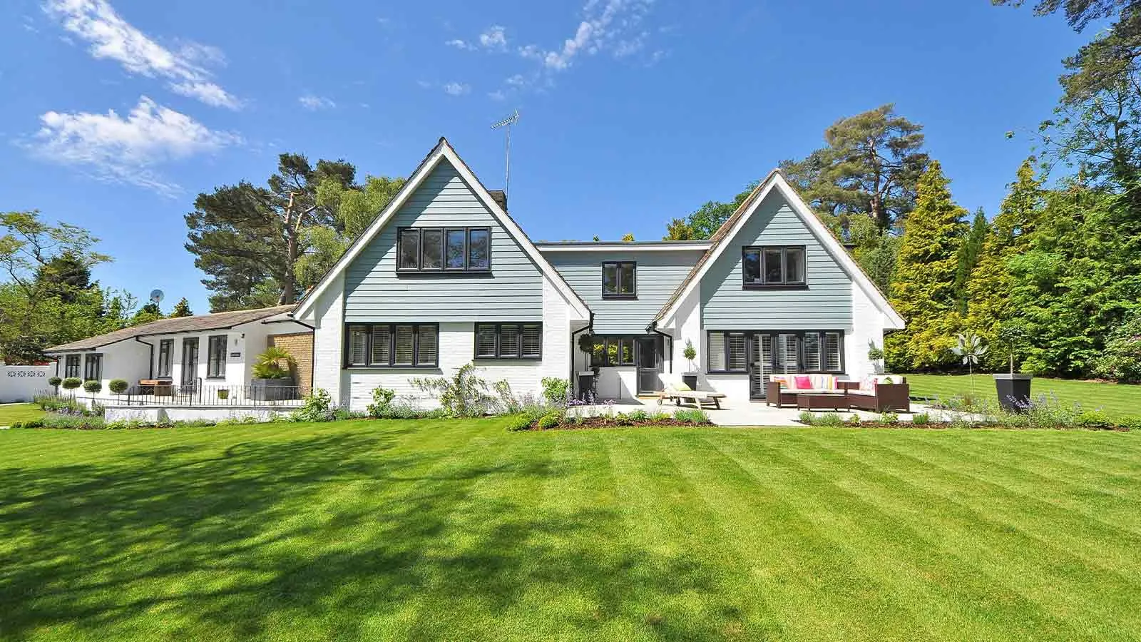 White gabled house on a large lawn, marketable only after title defects are cleared