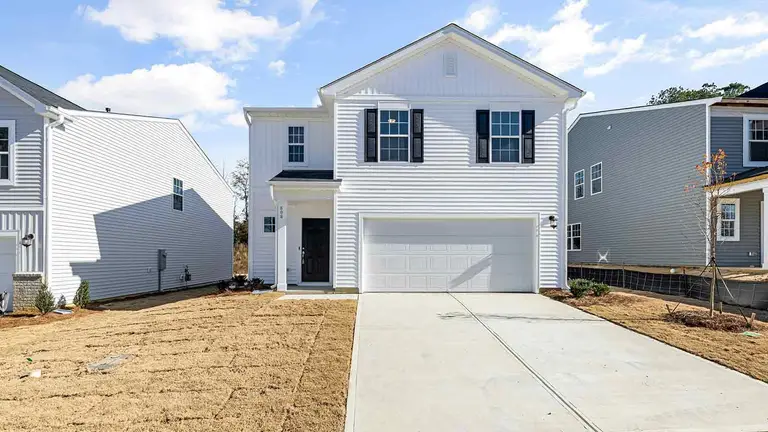 White suburban home with driveway, the largest asset a probate title search documents