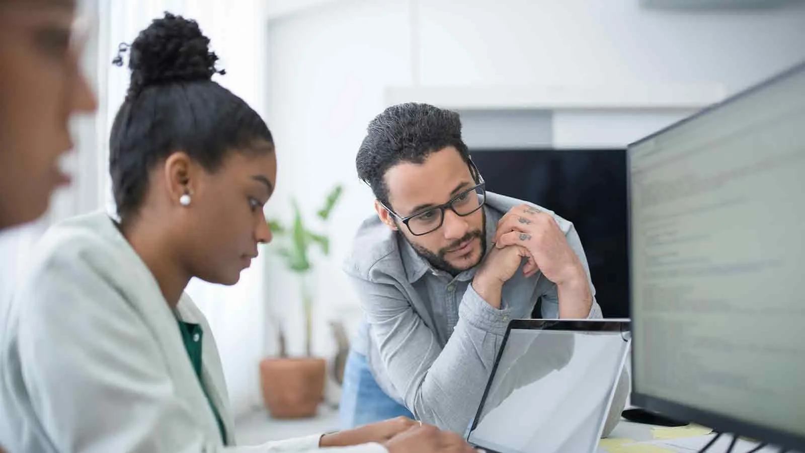 Estate attorney and staff reviewing probate title search results at a monitor