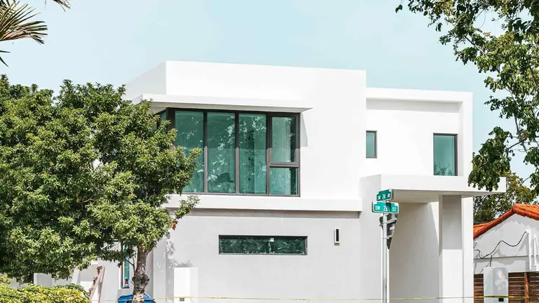White modern home on a corner lot, a prime target profile for title theft