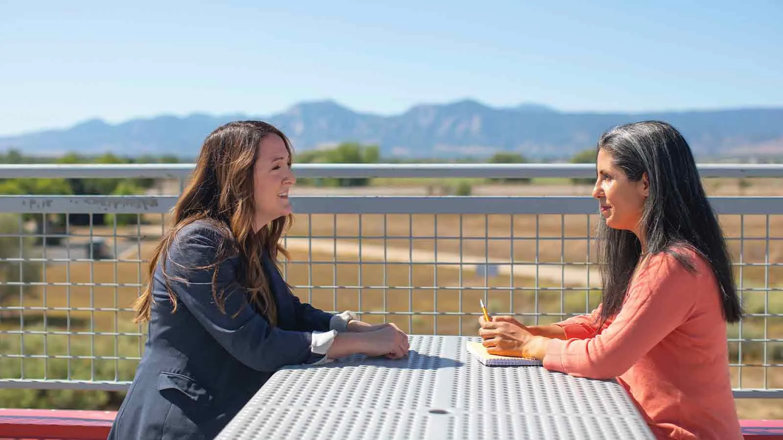Two agents comparing title resources and guaranty options on a terrace