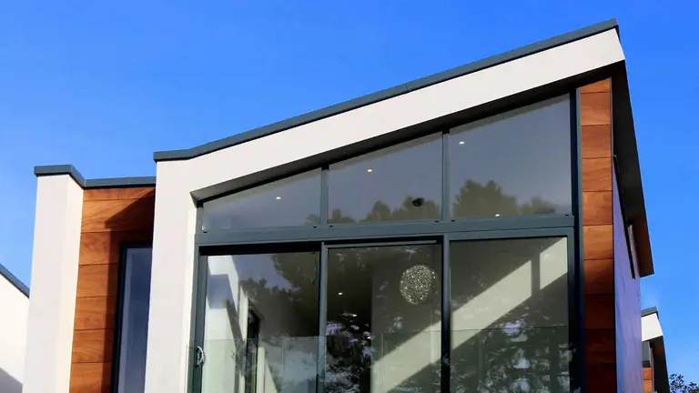 Angular modern home with glass walls, a deal protected by title service lawyers