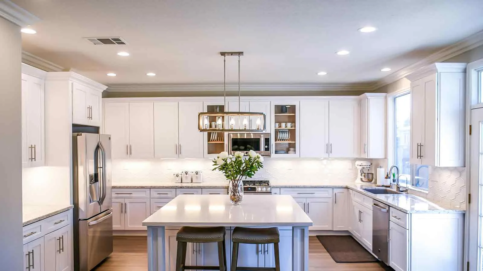 White kitchen with center island in a home closed by title service lawyers